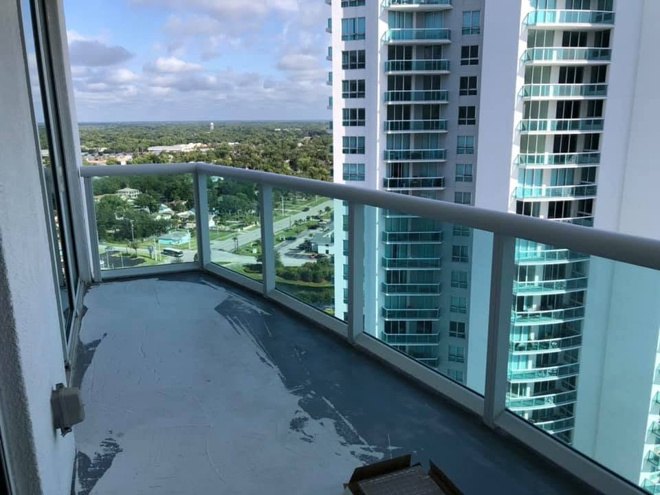 Before: bare concrete high-rise balcony