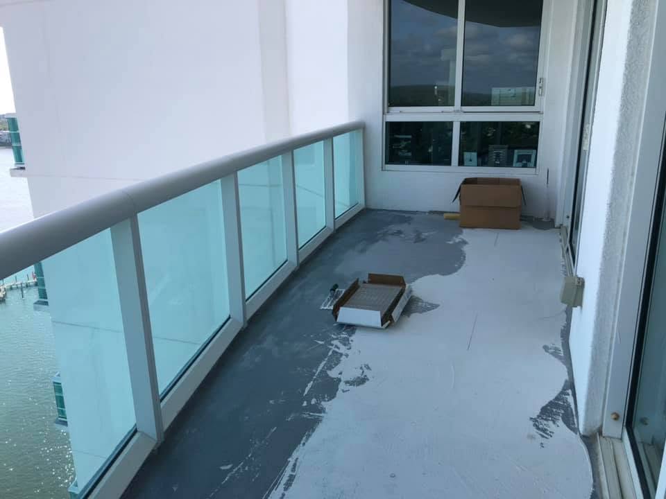 Before: bare concrete waterfront balcony