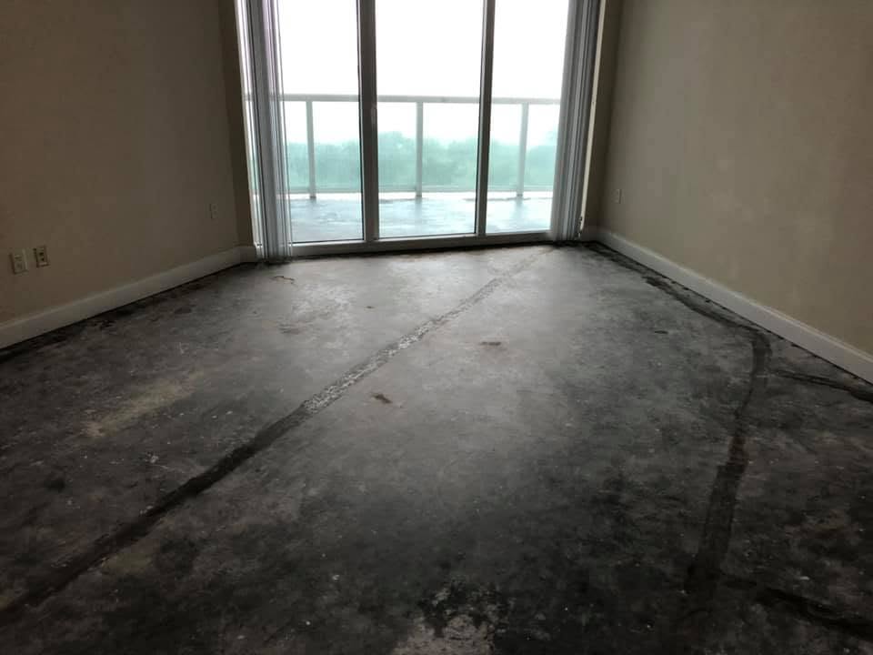 Before: bare concrete condo floor