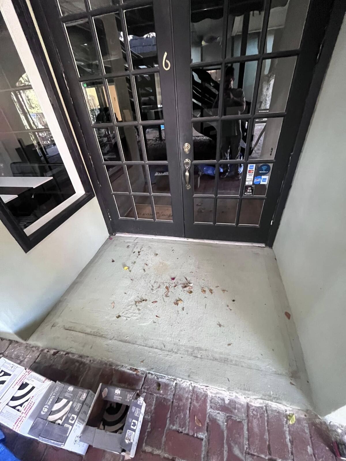 Bare concrete entryway prepped for tile installation