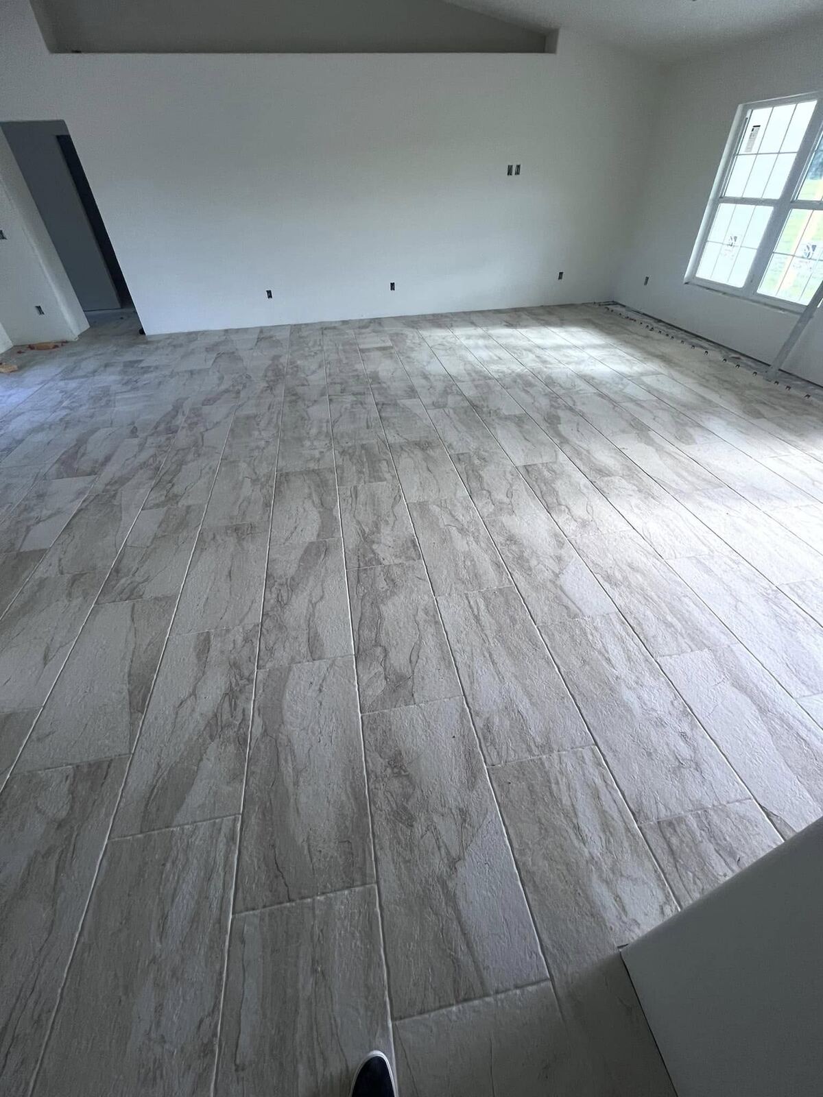 Finished large-format tile flooring, bedroom